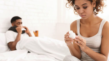 Woman looks at bottle of pills