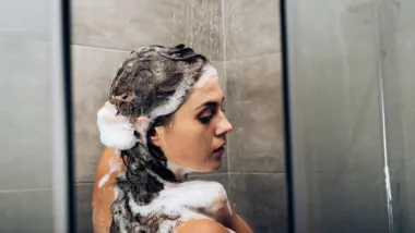 woman using matrix biolage shampoo to wash her hair in the shower