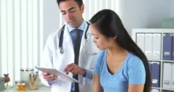 Woman with her doctor looking at test results