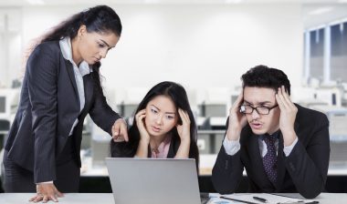 Three bank employees look worried.