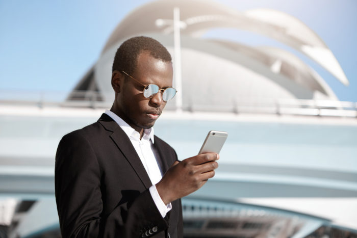 business man receiving unwanted text from schumacher automotive