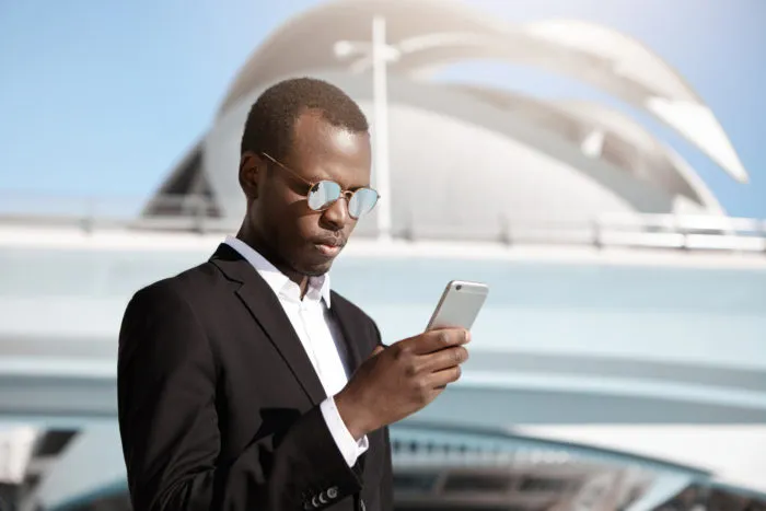 business man receiving unwanted text from schumacher automotive