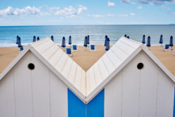 Two huts face the beach.