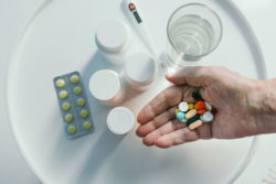 Close-up of hand holding pills.