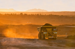 A truck carries coal from a mine.