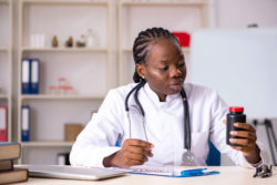 Doctor looking at prescription bottle
