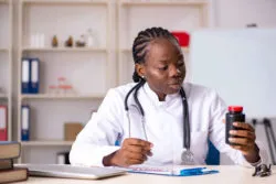 Doctor looking at prescription bottle