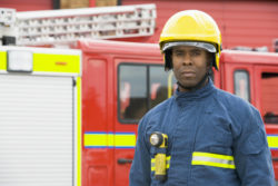 Fireman standing by engine
