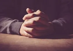 Two hands folded in prayer