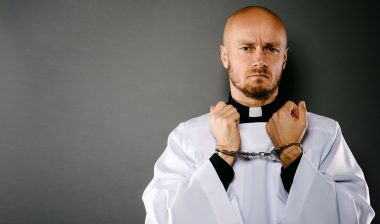 Handcuffed priest