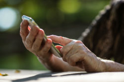 Two hands hold a smartphone.