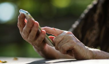 Two hands hold a smartphone.