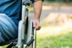Male hand on wheelchair