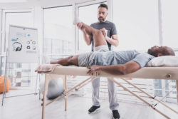 Man at physical therapy for knee pain.