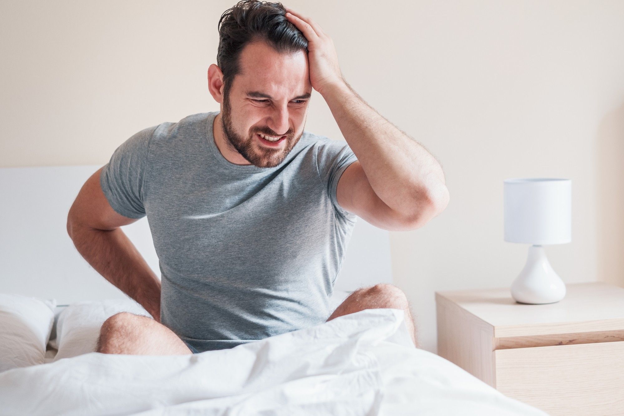 man suffering hernia mesh implant complications