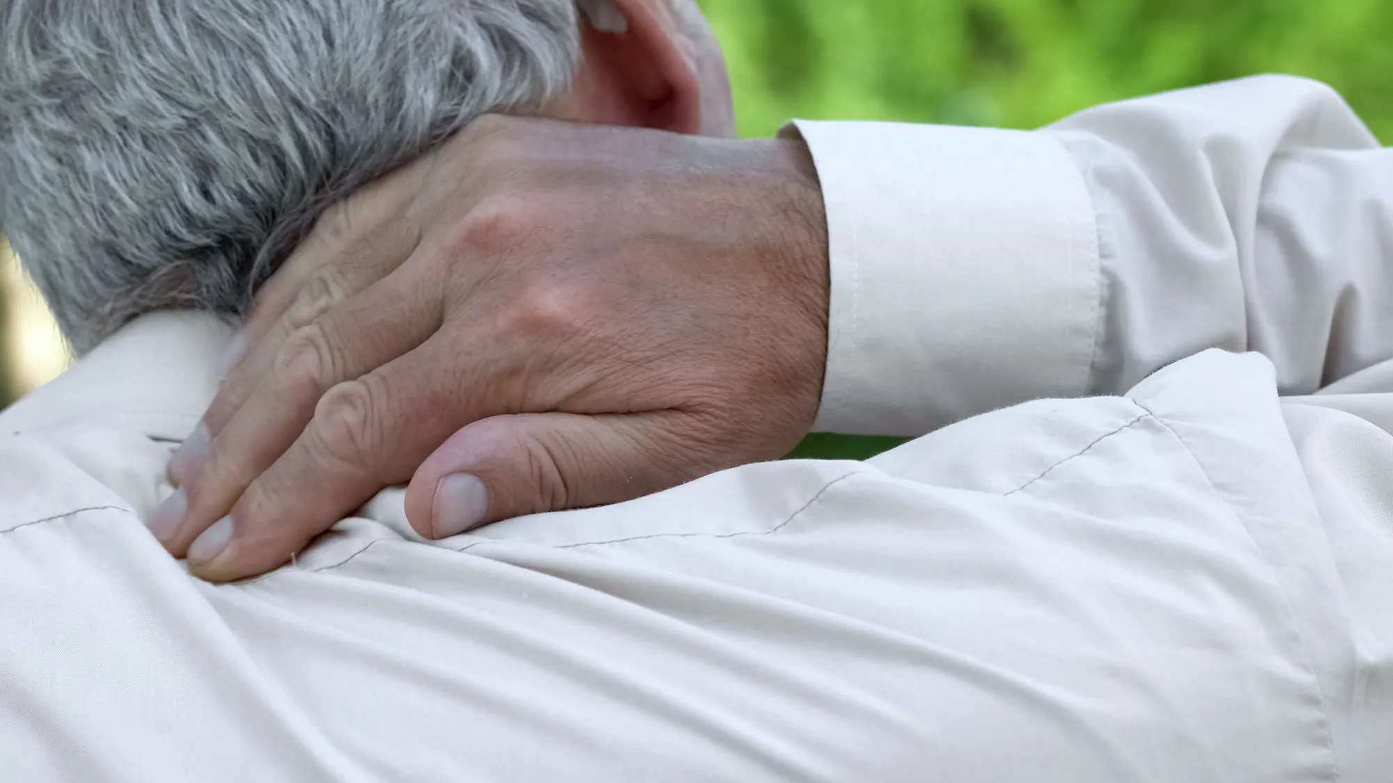 Man with gout massaging neck
