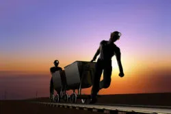 A coal miner pulls a cart.