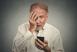 Older man receiving worrisome call