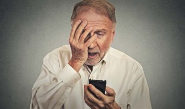 Older man receiving worrisome call