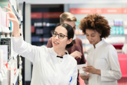 Two pharmacists work in a pharmacy.