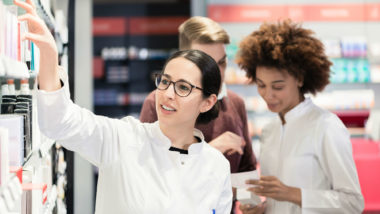 Two pharmacists work in a pharmacy.