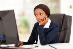 Woman at computer thinking