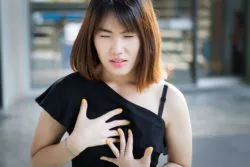 Woman suffering from heartburn