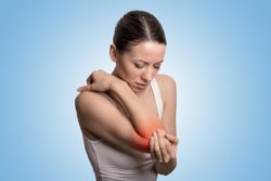 Young woman with elbow pain