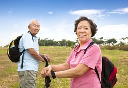 A couple on a hike, stopping in a field