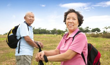 A couple on a hike, stopping in a field