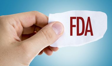 Hand holding paper with FDA sign