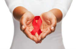 Hands holding AIDS awareness ribbon