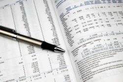 Investment report with pen