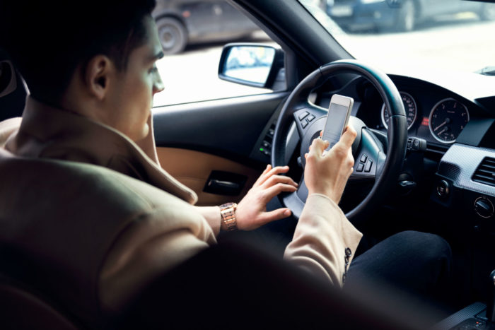 Man texting while driving
