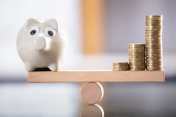 Piggy bank balancing coins