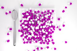 Purple pills on a white plate