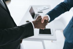 Two lawyers shake hands.