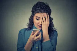 Surprised woman looking at phone