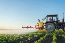 Tractor spraying crops