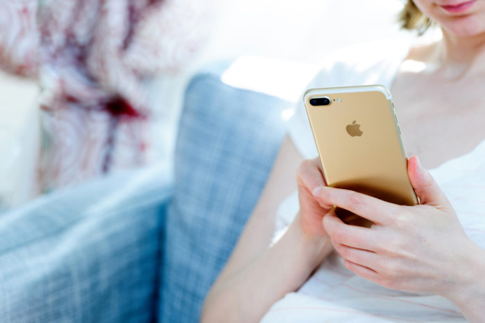woman holding apple iphone 7