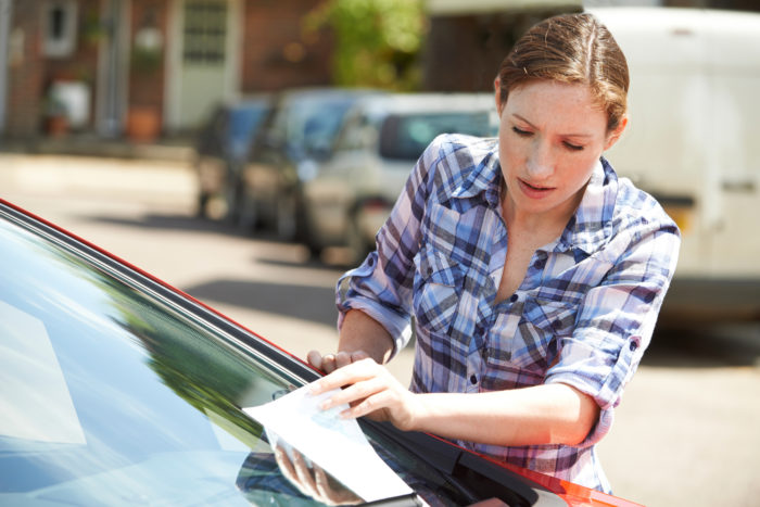 san diego woman looking at parking ticket