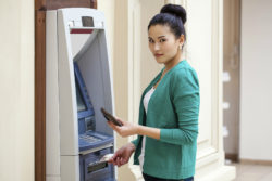 Woman using ATM