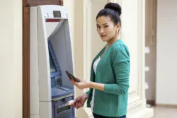 Woman using ATM