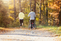 Young family running with jogging stroller