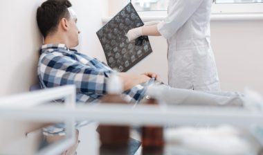 Young man with a concussion in a doctors office