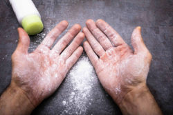 Baby powder bottle, powder sprinkled on hands