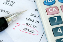Bank statement with a calculator marked with question