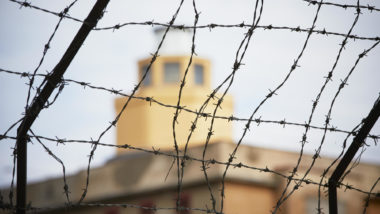 Barbed wire with tower in the background