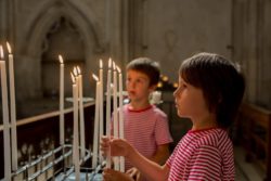 Boys place candles in church