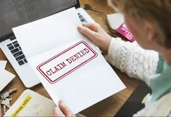 Woman opening claim denied letter